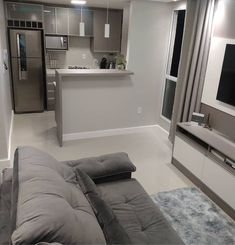 a living room filled with furniture and a flat screen tv on top of a wall