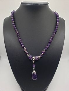 "This listing is for one (1) natural Amethyst beaded necklace with a matching teardrop shaped pendant. This necklace has both mainly 6mm beads and two 7mm and two 10mm beads on each side of the pendant. The teardrop shaped pendant hangs down about 2\" from the necklace with the pendant itself measuring .86\" long by .53\" wide. This necklace has an 18 - 19.5 inch adjustable length with a silver tone lobster claw clasp. This stunning, natural Amethyst is a statement piece with over 140 ctw of Ame Briolette Necklace, Beautiful Beaded Necklaces, Beaded Pendant Necklace, Beaded Crafts, Amethyst Beads, Beaded Pendant, Pretty Jewellery, Jewelry Crafts, Beaded Jewelry