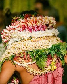 the back of a woman's head covered in flowers