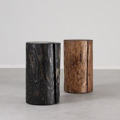 two wooden stools sitting next to each other