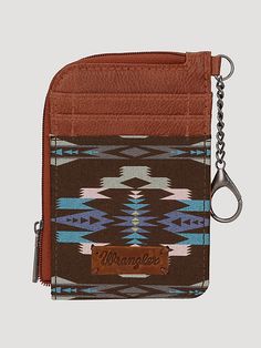 Southwestern art print on canvas Two credit card slot Zip-top closure, fabric lining Wrangler logo "W" on the back Attached split key ring Double round handle (drop: 5.75") 10.5" X 3.5" Western Hey Dudes, Western Things, Homesteading Animals, Cowgirl Vibes, Western Gifts, Southwestern Art, Southwestern Print, Round Handle, Hey Dude