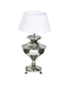 a silver lamp with a white shade on it