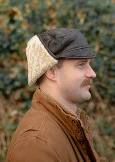 A beautifully crafted genuine sheepskin trapper hat that is both practical and stylish. Made with soft Nappa leather bound with a genuine real sheepskin inner, sheepskin and leather sides and sheepskin ear detail. The ear flaps can be clipped together either under the chin for cold weather or over the top for less windy days. Hand wash only. Sizes. Medium - 60cm. Large - 62cm. XLarge - 64cm. All Photographs and illustrations including but not limited to size and care guides are protected by copyright of the owner Lambland Limited. Copying, altering and using this copyrighted material will result in legal action. Images not owned by Lambland have been licensed for use through the creator. Brown Leather Hats With Faux Fur Lining, Leather Hat With Ear Flaps For Outdoor, Leather Hats With Faux Fur Lining And Ear Flaps, Sheepskin Hats With Ear Flaps For Outdoor, Sheepskin Outdoor Hat With Ear Flaps, Hat With Ear Flaps, Trapper Hat, Leather Workshop, Trapper Hats