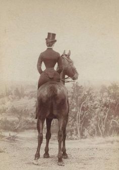 an old photo of a woman on a horse