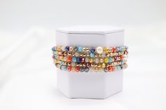 The Gold Multi Stone Bead Bracelet Set is a vibrant collection of bracelets adorned with an array of colorful stone beads, each accented with elegant gold touches. This set offers a versatile and eye-catching accessory option, perfect for adding a splash of color and sophistication to any outfit. Size: 6” - Inner Diameter Closure: Elastic Material: Zinc, Brass and Steel with Rhodium Plating Lead and Cadmium Safe - It is not Nickel Free Multicolor Pearl Bracelet With Gemstone Beads, Elegant Multicolor Stackable Beaded Bracelets, Gold Wrap Bracelet With Colorful Beads As Gift, Multicolor Gemstone Beaded Bangle Bracelets, Gold Wrap Bracelet With Colorful Beads, Multicolor Gemstone Beads Bangle Bracelet, Elegant Multicolor Wrap Bracelet With Round Beads, Adjustable Multicolor Jewelry With Gold Beads, Adjustable Multicolor Pearl Bracelet With Gemstone Beads