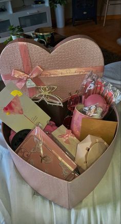 a heart shaped box filled with lots of different items