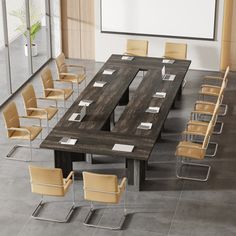 a conference table with chairs around it and a projector screen in the back ground