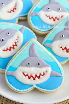 decorated cookies with blue and white icing depicting shark teeth on top of each cookie