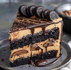 a piece of cake with oreo cookies and chocolate frosting is on a plate