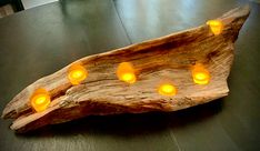 a piece of wood with candles on it