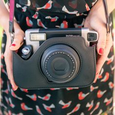 a woman holding a camera in her hands