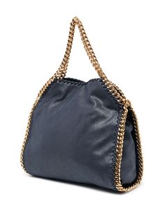 small Falabella tote bag from STELLA MCCARTNEY featuring indigo blue, gold-tone hardware, signature diamond-cut chain-link trim, adjustable detachable shoulder strap, two chain-link top handles, foldover top with magnetic fastening, logo charm and internal patch pocket. We've partnered with Good On You — an independent agency that rates how brands perform in relation to their impact on the planet, people and animals, with a multi-criteria rating simplified to a five points scale. In order to be Stella Bag, Mood Indigo, Stella Mccartney Falabella, Stella Mccartney Bag, Latest Fashion Design, Small Tote Bag, Crossbody Tote Bag, Mini Tote Bag, Small Tote