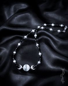 In honour of Artemis, Goddess of the wilds and Goddess of the moon. She who wears the crescent moon crown. An enchanting beaded strand featuring a Selenite sphere framed by crescent moons, and strung between black Onyx and silver freshwater pearls. This necklace depicts the Triple Goddess symbol,  the Selenite bead in the centre symbolising the full moon with a waxing and waning crescent on either side.  The crescent moon beads are produced in sterling silver and are uniquely textured by hand gi Bohemian Moon Phase Round Beaded Jewelry, Festival Jewelry With Moon Charm And Round Beads, Celestial Round Beads Jewelry For Festival, Celestial Style Festival Jewelry With Round Beads, Mystical Beaded Jewelry, Celestial Beaded Jewelry For Festivals, Bohemian Moon-shaped Beaded Jewelry, Bohemian Beaded Crescent Jewelry, Bohemian Moon Shaped Beaded Jewelry