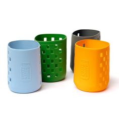 four different colored cups sitting next to each other