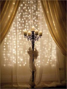 an image of a chandelier in front of a window with lights on it