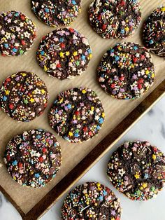 chocolate cookies with sprinkles on a baking sheet