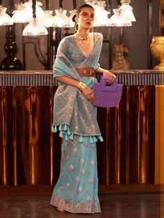 Introducing an exquisite sky-blue silk saree adorned with intricate copper zari weaving work, the epitome of elegance and charm. Perfect for weddings, festivals, functions, and other special occasions, this saree beautifully blends timeless tradition with contemporary style. The vibrant sky-blue color exudes a refreshing and serene appeal, while the detailed copper zari work adds a touch of opulence and sophistication, making it a standout choice for any event.
The saree comes with a matching si Weaving Linen, Wedding Sarees Online, Blue Silk Saree, Wedding Saree Collection, Turquoise Blue Color, Wedding Saree Indian, Linen Saree, Blue Saree, Wear Saree