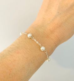 A dainty pearl bracelet available in many colours, perfect as a gift for your bridesmaids. It has an extender chain so it can be adjusted as required.  Each bracelet will come in its own pretty organza bag, so it would make a lovely gift.  Please choose your colour from the drop-down box shown. Minimalist Sterling Silver Pearl Bracelet For Wedding, Elegant Adjustable Bridesmaid Bracelets, Elegant Bridesmaid Bracelets, Dainty Silver Pearl Bracelet For Bridesmaid Gift, Silver Dainty Pearl Bracelet For Bridesmaid, Classic Silver Pearl Bracelet For Bridesmaids, Adjustable Pearl Chain Bracelet For Bridesmaid Gift, Classic Pearl Bracelet For Bridesmaid Gift, Delicate Sterling Silver Pearl Bracelet For Wedding