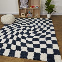 a blue and white area rug with an elephant toy on the floor next to it