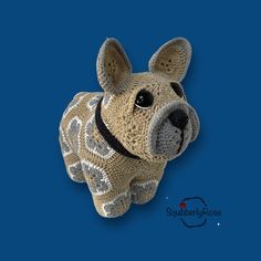 a crocheted stuffed animal is shown on a blue background