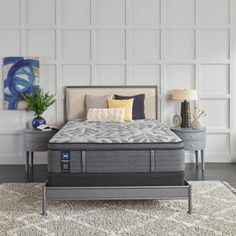 an image of a bedroom setting with mattresses and pillows on the bed side table