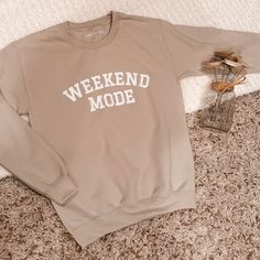 Tan sweatshirt with white Weekend Mode text .  All sweatshirts are personally designed and heat pressed on high quality Gildan sweatshirts. 50/50 cotton/poly, heavyweight, tear away label and machine washable. Unisex sizing, therefore these run large but give a perfect oversized vibe. Size down if you prefer a smaller fit. Check the size chart for reference.  Your item is handmade with love, therefore please treat it with love. It is recommended to wash inside out and dry on low heat/hang to dry for best long-term results.  Please allow 1-2 weeks for delivery. No returns or exchanges, but please contact me if you have any problems with your order. Oversized Comfortable Sweatshirt With Letter Print, Oversized Comfortable Sweatshirt With Graphic Print, Oversized Comfy Sweatshirt With Letter Print, Trendy Crew Neck Sweatshirt For Loungewear, Relaxed Fit Letter Print Trendy Sweater, Relaxed Fit Letter Print Sweater, Trendy Relaxed Fit Sweater With Letter Print, Trendy Oversized Slogan Sweatshirt, Cozy Text Print Sweatshirt For Streetwear