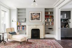 a living room filled with furniture and a fire place in the middle of a room