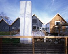 the house is made out of wood and has two stories on each level that are connected to one another