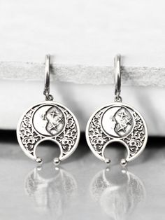 Embrace the mystique of the moon with these stunning half moon earrings. Handcrafted from high-quality sterling silver, these lunula earrings feature an intricate design inspired by Viking jewelry and celestial themes. Perfect for those who love boho style and lunar symbolism, these earrings capture the beauty and mystery of a lunar eclipse. These sterling silver lunula earrings are both elegant and durable, making them ideal for everyday wear or special occasions. The detailed craftsmanship reflects the timeless appeal of Viking jewelry while adding a modern boho twist. Whether you're looking for a unique accessory or a thoughtful gift, these half moon earrings are a perfect choice. Celebrate the celestial charm and Viking heritage with these exquisite half moon earrings. Their handcrafte Celestial White Gold Sterling Silver Earrings, Symbolic Silver Sterling Silver Plug Earrings, Symbolic Nickel-free Crescent Jewelry, Celestial Moon Phase Moon Earrings, Silver Symbolic Drop Earrings, Bohemian Crescent Sterling Silver Earrings, Symbolic Silver Drop Earrings, Silver Spiritual Moon Phase Earrings, Bohemian Sterling Silver Crescent Earrings