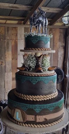 a three tiered cake with horses on top