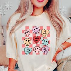 a woman wearing a t - shirt that says i love you with emoticions on it