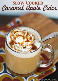 a close up of a cup of coffee on a plate with the words slow cooker caramel apple cider