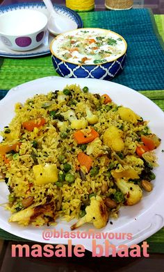 a white plate topped with rice and vegetables