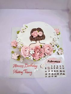 a birthday card with flowers and a woman's face on the top of it