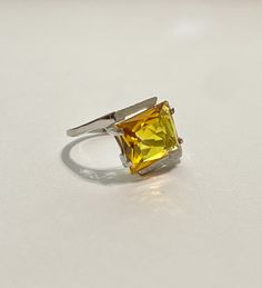 This Vintage 10k White Gold Yellow Sapphire Ring is magnificent! The ring showcases a Emerald set in a four prong setting The Sapphire stone has beautiful color. The stone measures approximately 10mm x 12mm = 6.84 carats The setting is beautiful with a unique style The ring is marked U - 10k Weight- 3.61g Size-7 Classic Yellow Topaz Ring For Formal Occasions, Yellow Hallmarked Topaz Promise Ring, Classic Yellow Topaz Ring In Prong Setting, Hallmarked Yellow Topaz Promise Ring, Classic Yellow Topaz Ring With Prong Setting, Classic Yellow Topaz Promise Ring, Classic Yellow Topaz Ring For Promise, Classic Yellow Hallmarked Topaz Ring, Classic Yellow Topaz Ring In 14k Gold