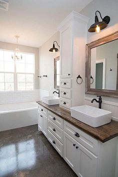 a bathroom with two sinks and a large mirror