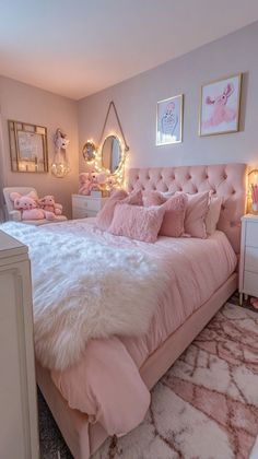 a bedroom with pink bedding and white fur rugs