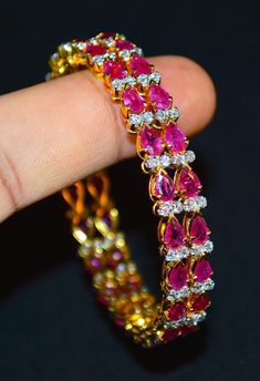 "1 solid 18k gold 10.35cts diamond and ruby bangle f-g color and vs clarity untreated natural diamonds and untreated natural pinkish red rubies. extremely high end - top quality bangle (i have 2 bangles, but this listing is of one bangle. please contact me if you are interested in both bangles) here is the description of one bangle: this is a custom made top quality ruby and diamond bangle. the bangle is loaded with 1.71cts of round brilliant cut diamonds and 22 pear cut natural red rubies total Ruby And Diamond Bangles, Red Cubic Zirconia Bangle, Diamond Bangle In Yellow Gold For Party, Yellow Gold Diamond Bangle For Party, Diamond Bangle With Accents For Party, Diamond Bangle With Diamond Accents For Party, Elegant Diamond Bangle With Gemstones, Party Yellow Gold Diamond Bangle, Elegant Ruby Bangle With 17 Jewels