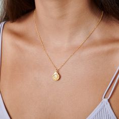 Transport yourself to a paradisiac beach with the gorgeous and delicate Gold Shell Pendant with Pearl Necklace. This tiny simple necklace features a 14K gold-filled chain and gold shell pendant with an adorable freshwater pearl. This dainty shell necklace is a beautiful gift for a June birthday. MATERIALS: 14K Gold Filled 14K Gold Filled jewelry is not the same as gold-plated jewelry. It contains 5% of solid gold and is done by a process of heat bonding. The layer of gold is permanently bonded w Seashell Charm Necklace, Silver Coin Jewelry, Tiny Pendant Necklace, Personalized Gold Jewelry, Necklace With Pearl, Pearl Charm Necklace, Outfit Choices, Delicate Gold Necklace, Gold Circle Necklace