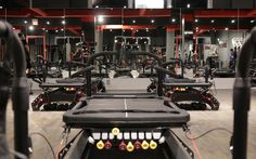 an indoor gym with rows of exercise equipment