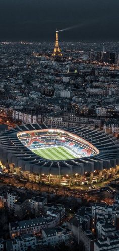 an aerial view of the eiffel tower and soccer stadium in paris at night