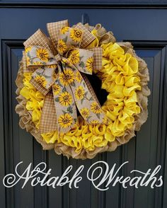 a yellow wreath with sunflowers and burlocks hanging on the front door