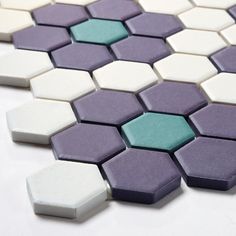 a white and purple tile with hexagonal tiles on it's sides,