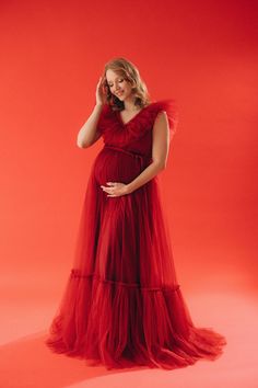 "The red wine dress, a symbol of timeless beauty, complements your changing silhouette with its flowing lines and luxurious fabric. Indulge in the perfect blend of comfort and style with our maternity maxi dress, designed to enhance the beauty of pregnancy in every frame. Elevate your pregnancy photoshoot experience with a touch of opulence and capture the magic of this special journey. As part of our Black Friday promotion, explore our plus-size gown collection. * Dress name: Charlotte * Large color palette - contact our manager for detailed information * Size: XS-S, S-M, M-L, L-XL, XL-2XL, 2XL-3XL, 3XL-4XL, CUSTOM SIZE * Shipping: 7-14 business days. FREE SHIPPING * Processing time: 10-14 business days For a better fit please measure yourself and send me your measurements: -Your height - Luxury Fitted Tulle Maxi Dress, Luxury Fitted Maternity Maxi Dress, Red Dress Maternity Shoot With Family, Photo Shoot Style, Red Wine Dress, Red Tulle Dress, Tulle Maternity Dress, Dress For Photoshoot, Lace Up Back Dress