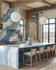 a large kitchen with marble counter tops and wooden chairs in front of an island that's surrounded by windows