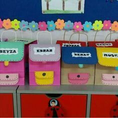 several bags with name tags on them sitting on top of a shelf in a room