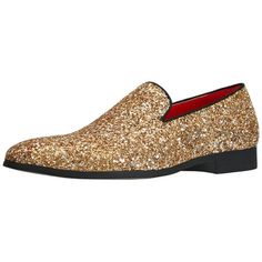 a gold shoe with black soles and glitter on the bottom, in front of a white background