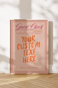 a pink poster with the words guest check on it in front of a white wall