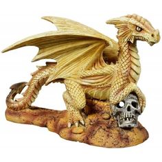 a golden dragon figurine sitting on top of a rock