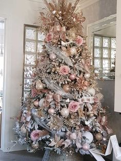 a christmas tree decorated with pink and gold ornaments